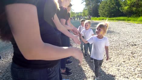 Jugendliche-und-Kinder-Teams-begrüßen-einander-mit-Handschlag-am-sonnigen-Sommertag