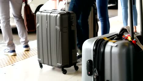 4K-footage-of-passenger-with-big-roller-luggage-standing-on-the-line-waiting-for-taxi-queue-at-taxi-parking-lot-at-airport-arrival-terminal