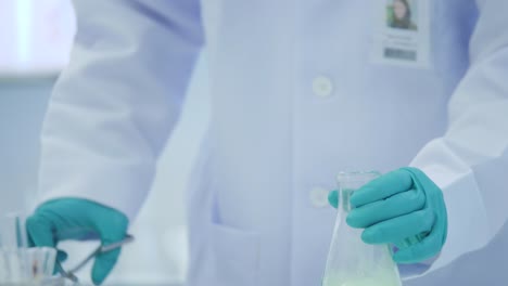 Female-medical-research-scientists-put-dry-ice-into-a-glass-beaker