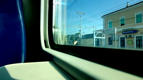 Low-angle-view-from-the-window-of-a-departing-train.