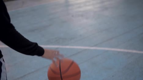 Weibliche-Basketballspielerin-training-Basketball-spielen.-Basketball-Spieler-Prellen-des-Balls.-Slow-Motion-Aufnahme-des-Basketball-Spieler-auf-dem-Platz-im-freien-training