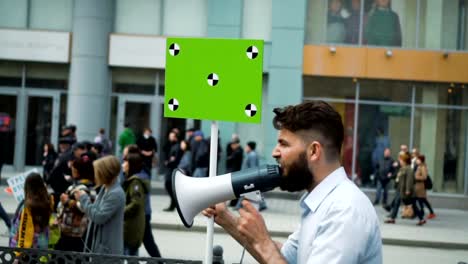 A-man-goes-to-a-rally-with-a-megaphone-in-his-hands-in-slow-motion-closeup.