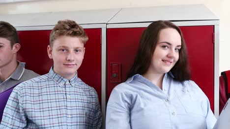 Portrait-Of-High-School-Students-With-Friends-In-Corridor