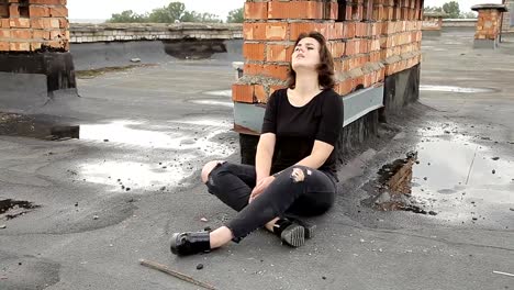 Teen-girl-in-depression-sitting-on-the-roof-of-a-building