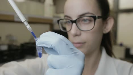 A-handheld-shot-of-a-researcher-pipetting-samples-in-a-genetic-laboratory-at-university