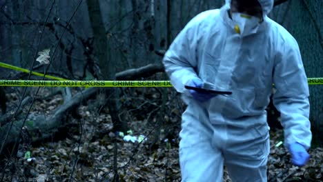 Forest-crime-scene,-forensic-science-expert-working-at-site,-evidence-collection