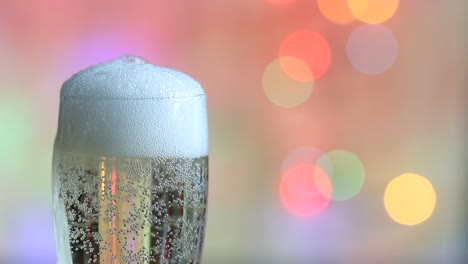 Glass-of-champagne-and-colorful-defocused-new-year-party-background