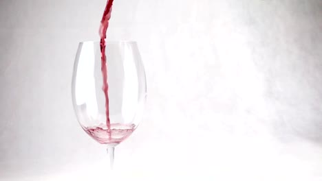 Pouring-wine-into-a-glass-with-drops-in-slow-motion