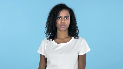 African-Girl-Gesturing-Thumbs-Down-Isolated-on-Blue-Background