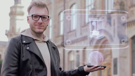 Smart-young-man-with-glasses-shows-a-conceptual-hologram-safe-with-money