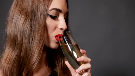 Woman-Drinks-Champagne-at-New-Year-Party