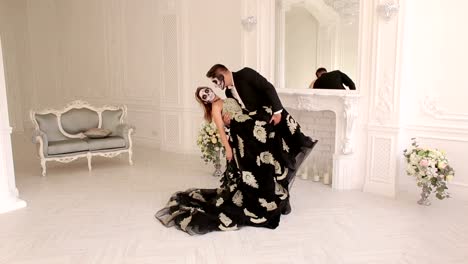 Halloween.-A-couple-with-makeup-on-their-face-in-a-room-with-a-vintage-interior.