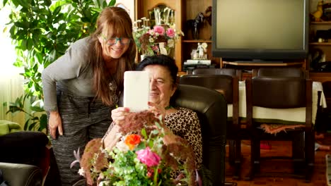 Senior-women-using-digital-tablet-for-video-call-with-family