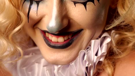 Close-up-portrait-of-an-excited-blonde-woman-with-make-up-in-halloween.