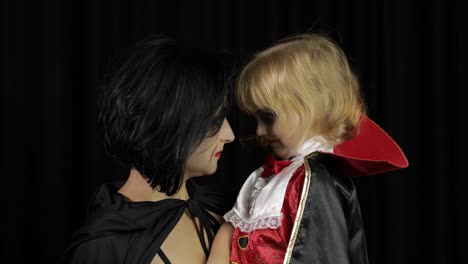 Woman-and-child-dracula.-Halloween-vampire-make-up.-Kid-with-blood-on-her-face