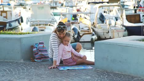 Woman-with-Daughter-Looking-at-a-Map-near-Marina