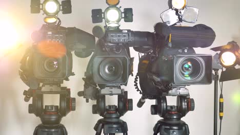 A-zooming-out-shot-on-three-brightly-lit-video-cameras.