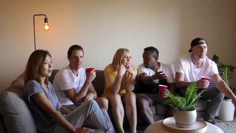 Group-of-young-multinational-adults-watching-TV.