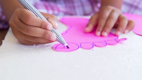 Close-up-kid-hands-using-the-colored-felt-pens-on-paper,-slow-motion-shot-in-100-fps