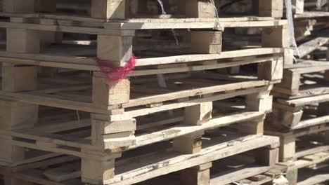 Wooden-pallets-stacked-in-the-warehouse.-Cargo-delivery-on-pallets