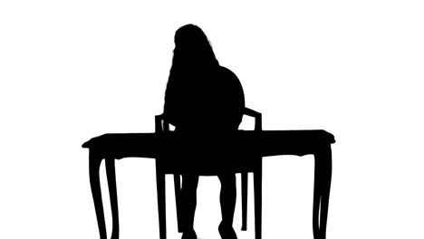 Silhouette-Cute-little-girl-doing-homework,-writing-down-track-matte