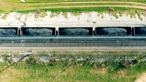 Carriages-with-coal-go-on-a-railroad,-top-view.