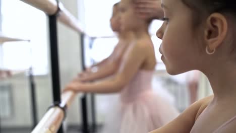 Girls-Exercising-at-Ballet-Barres