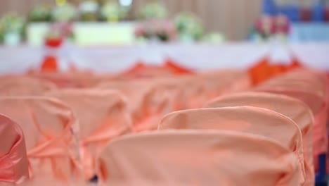 Blurred-of-meeting-room-with-orange-chairs-interior-of-modern-conference-seminar-hall