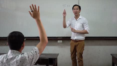 Young-Asian-foreign-oriental-language-instructor-giving-a-language-lesson-in-classroom
