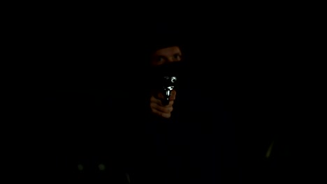 Aggressive-bandit-in-mask-threatening-handgun-at-camera,-dangerous-criminal