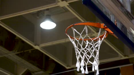 People-training-basketball-free-throw-and-missing.-Basketball-net-close-up.-Flat-plane.-Low-angle-shot