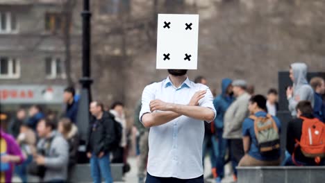 A-man-at-a-rally-with-a-changeable-emotion-on-his-head-waving-his-hands-4k.