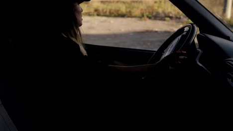 Staging-scene-of-a-scary-young-woman-sitting-in-a-van,-get-out-of-car-and-see-a-horror-picture-of-two-zombies-coming-directly-to-her.-Day-time.-Side-view