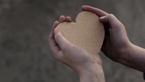 homeless-boy-holding-a-cardboard-heart