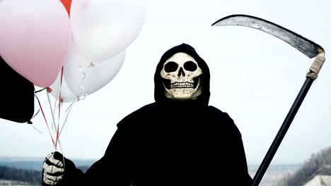 death-with-a-scythe-holds-balloons