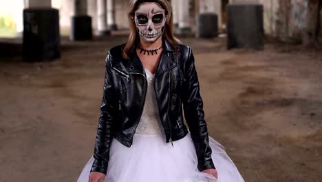 A-bride-with-a-creepy-skull-makeup-for-Halloween-in-an-abandoned-city.