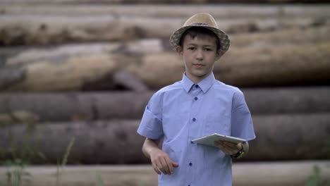 boy-is-standing-with-a-tablet-looking-at-the-camera-and-showing-a-like