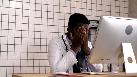 Afro-american-doctor-with-migraine-overworked,-overstressed.-Negative-human-emotions