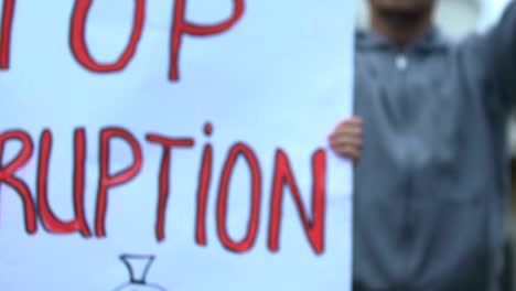 Female-worker-showing-banner-with-slogan-On-strike,-protection-of-employee-right