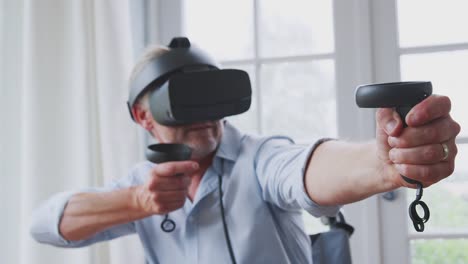 Senior-Disabled-Man-In-Wheelchair-At-Home-Wearing-Virtual-Reality-Headset-Holding-Gaming-Controller