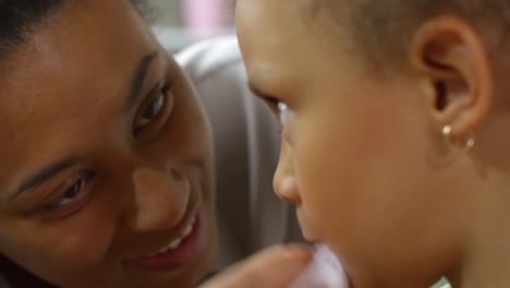 Mother-Removing-Makeup-from-Daughter’s-Face