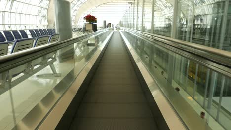 Sliding-airport-travelator.-Walking-fast-on-moving-walkway.-Subjective-view.