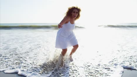 Portrait-of-laughing-African-American-female-paddling-barefoot