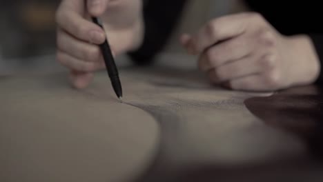 Close-up-of-womans-hand-painting-in-her-studio