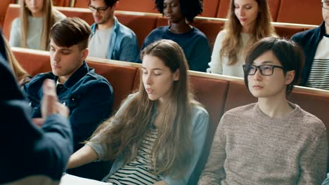 Camera-Facing-Class:-College-Professor-Gives-Lecture-to-a-Classroom-Full-of-Multi-Ethnic-Students.-Lecturer-Gesticulates-with-His-Hands-while-Students-Listen.