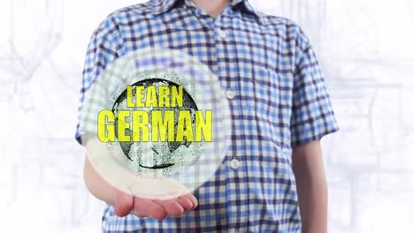 Young-man-shows-a-hologram-of-the-planet-Earth-and-text-Learn-German