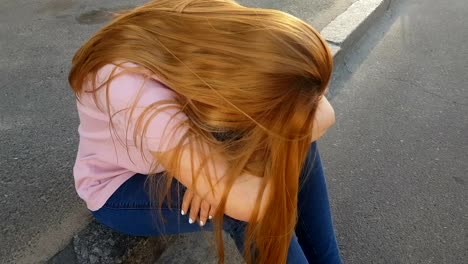 Frustrated-girl-sitting-on-sidewalk,-victim-of-pickpocket-crying-in-street