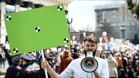 European-people-at-demonstration.-Man-with-a-banner-screaming-into-a-mouthpiece.