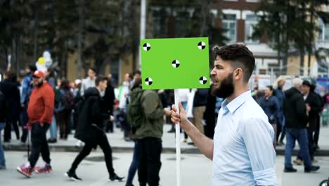 European-people-at-demonstration.-Man-with-a-banner-screaming-into-a-mouthpiece.