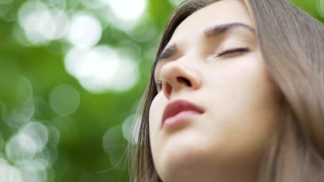 Woman-meditates-outdoors,-rack-focus,-beautiful-face,-peace-of-mind-inner-temple